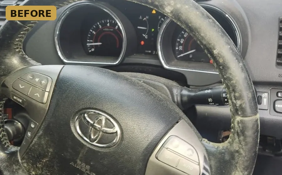 Before — grimy Toyota dashboard and steering wheel